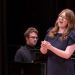 Senior music major Rita Schien singing with piano accompaniment at a recital at the Blanche M. Touhill Performing Arts Center
