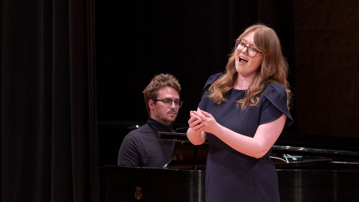 Senior music major Rita Schien singing with piano accompaniment at a recital at the Blanche M. Touhill Performing Arts Center