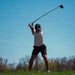 Golfer Logan Mayo prepares to hit a tee shot
