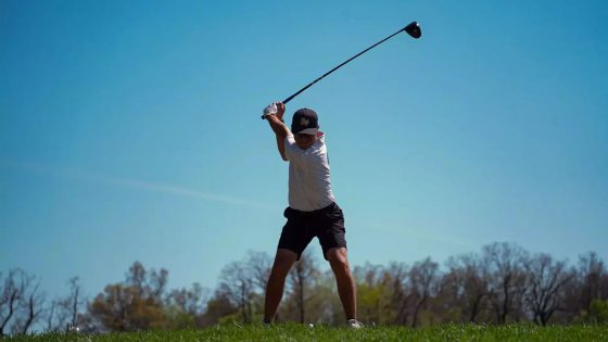 Golfer Logan Mayo prepares to hit a tee shot