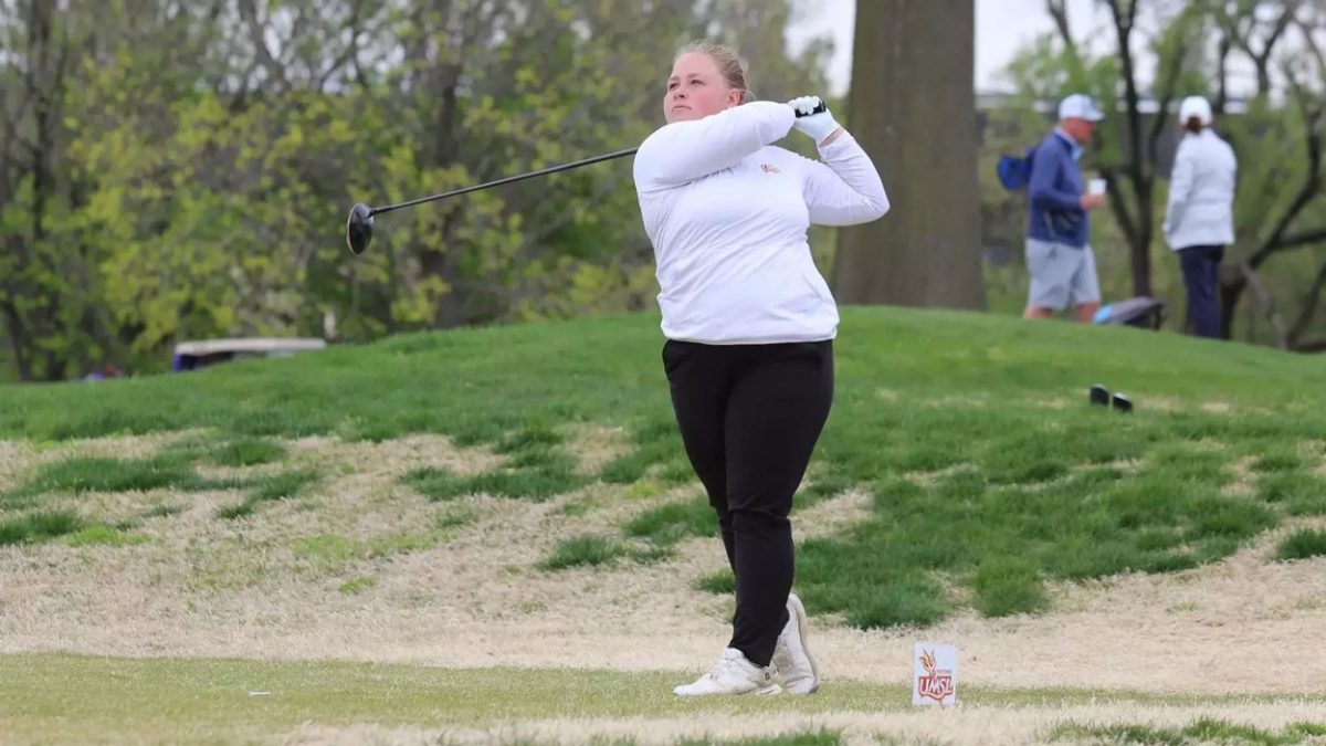 Women's golfer Wilma Zanderau follows through after hitting a tee shot