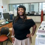 Zahria Patrick stands in a chemistry lab