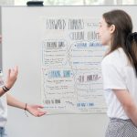 Pattonville rising senior Parker Bergfeld explains her project to adjunct instructor Hannah Rose