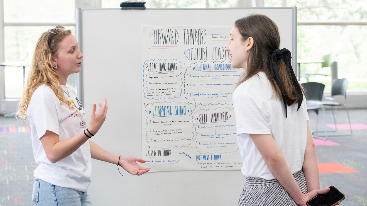 Pattonville rising senior Parker Bergfeld explains her project to adjunct instructor Hannah Rose