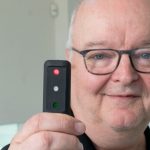 Curators' Distinguished Teaching Professor Carl Bassi holds up the Quantitative Three Dot test device