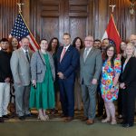 Gov. Mike Kehoe poses with leaders of organizations that are part of the Missouri Governor’s Challenge to Prevent Suicide among Service Members, Veterans, and their Families in his office in the Missouri State Capitol