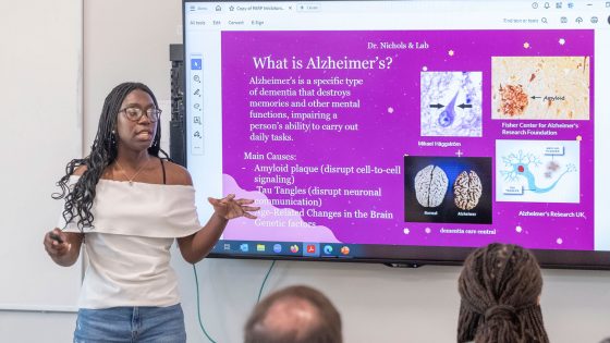 Intern Imani Mu'Min, a rising senior at Hazelwood East High School, gives a presentation about her experience in CLIMB, including research related to Alzheimer's disease while working in the lab of UMSL Professor Michael Nichols