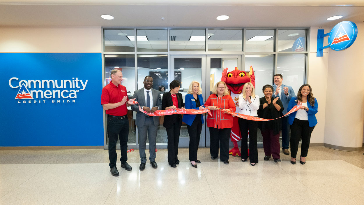 Chancellor Kristin Sobolik cuts a ribbon to mark the opening CommunityAmerica Credit Union's new branch in the Millennium Student Center