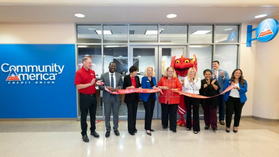 Chancellor Kristin Sobolik cuts a ribbon to mark the opening of CommunityAmerica Credit Union's new branch in the Millennium Student Center on Wednesday at the University of Missouri–St. Louis. Sobolik (center) was flanked by (from left) UMSL Entrepreneurship and Innovation Center Executive Director Scott Morris, Vice Chancellor Reggie Hill, Ed G. Smith College of Business Dean Shu Schiller, CommunityAmerica Credit Union St. Louis Market President Kathy O'Neill, Louie the Triton, CommunityAmerica Chief Marketing and Strategy Officer Whitney Bartelli and other officials from the credit union.