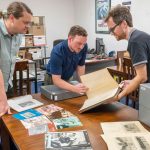 State Historical Society of Missouri St. Louis Research Center Coordinator A.J. Medlock (at right) shows archivists Mike McHugh and Zack Palitzsch Fontbonne University's student roster from 1924-1928.