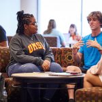 Students talking in a lounge space in the Millennium Student Center