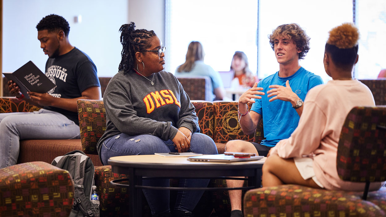 Students talking in a lounge space in the Millennium Student Center