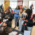 Ed G. Smith College of Business academic advisor Shylnda Hudson speaks with UMSL students about business minors and other opportunities in the college during the "Skills for the Future" event in the Millennium Student Center rotunda
