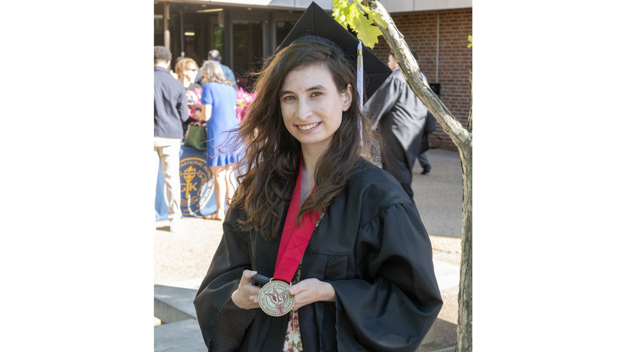 Isabelle Hermann poses with her commencement medal