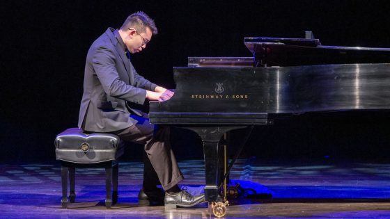 Supply chain student Eric Zhang plays the piano during the Founders Celebration