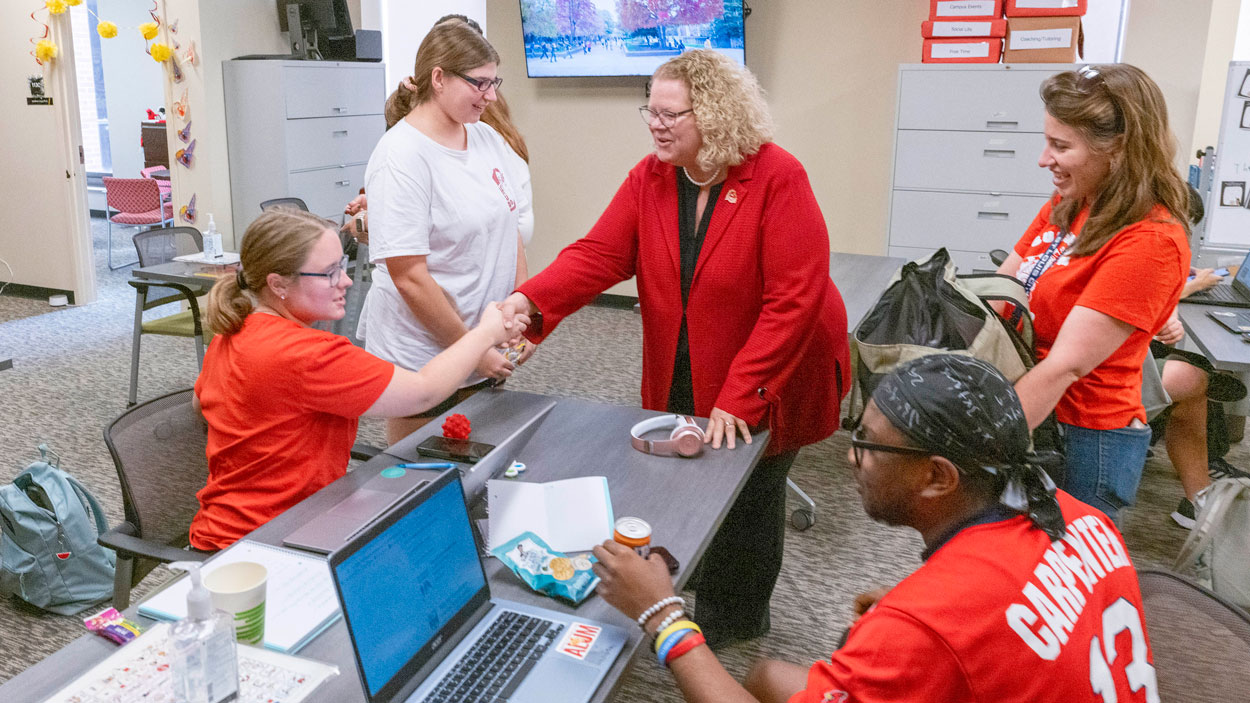 UMSL Chancellor Kristin Sobolik shakes hands and interacts with students