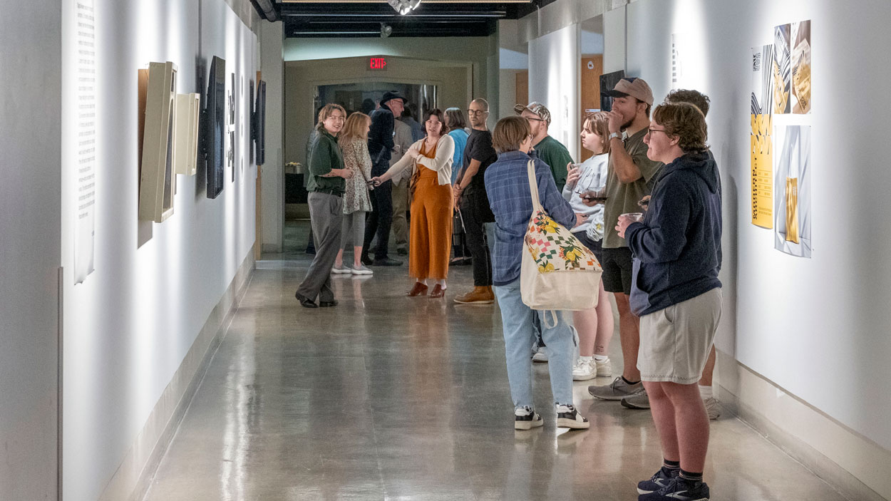 Students view pieces in "Digital Realms: An Exhibition of New Media Practices," the current exhibition in Gallery 210@FAB