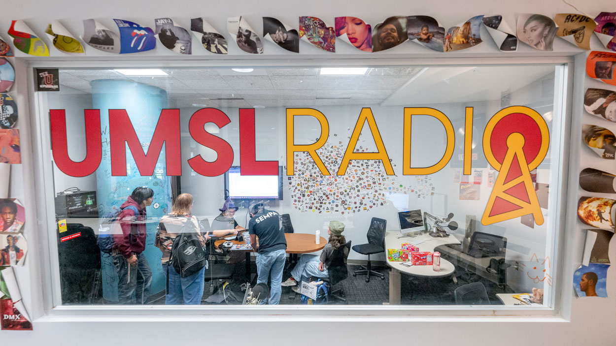 UMSL senior communications major and UMSL Radio DJ Remy Xa speaks with prospective DJs and students about UMSL Radio during a recent open house
