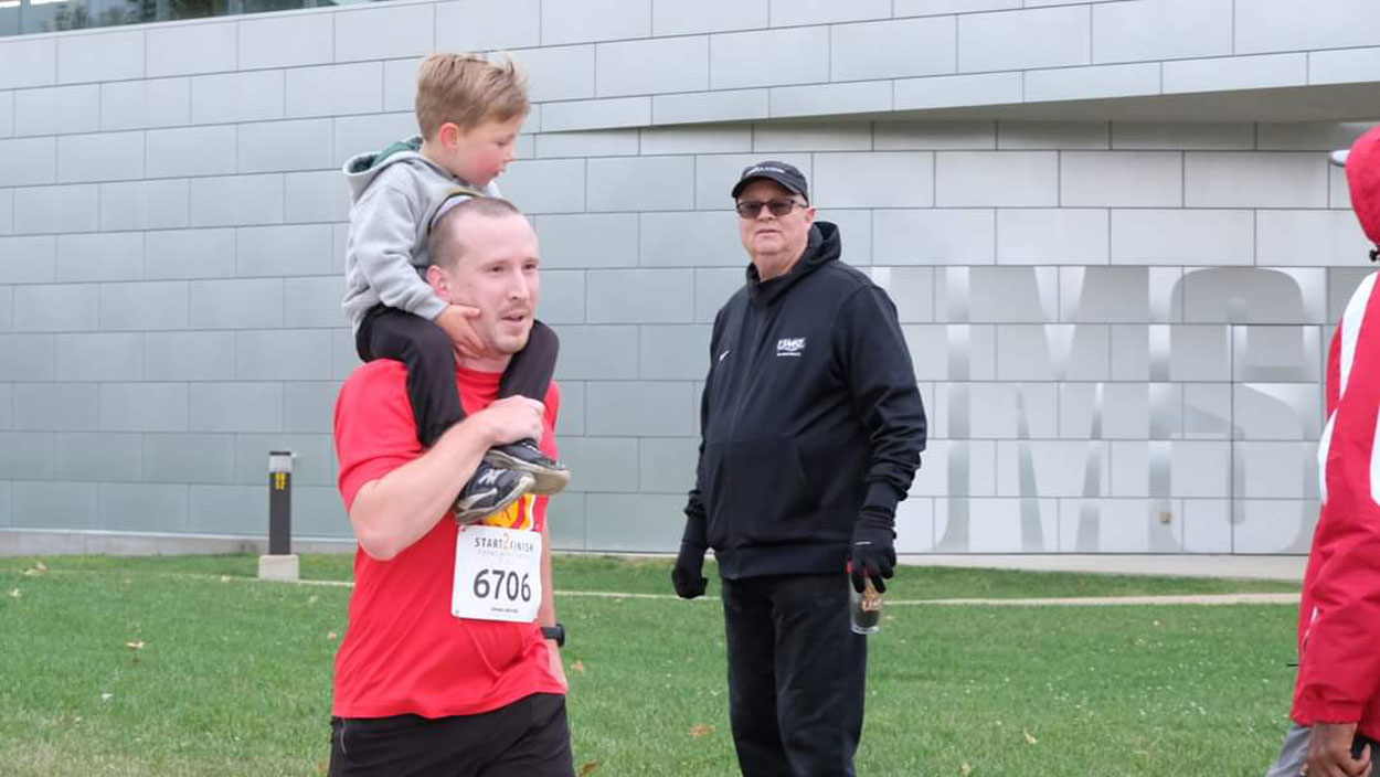 Samuel Fredeking runs in the UMSL 5K in 2023