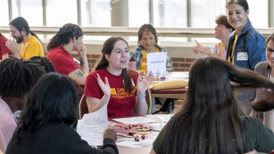 Modern Language major Claire Neske greets high school students in French during World Languages Day Activities held Friday in the lobby of the Blanche M. Touhill Performing Arts Center.