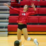 Outside hitter Alayna Santel leaps to swing at a ball in the air