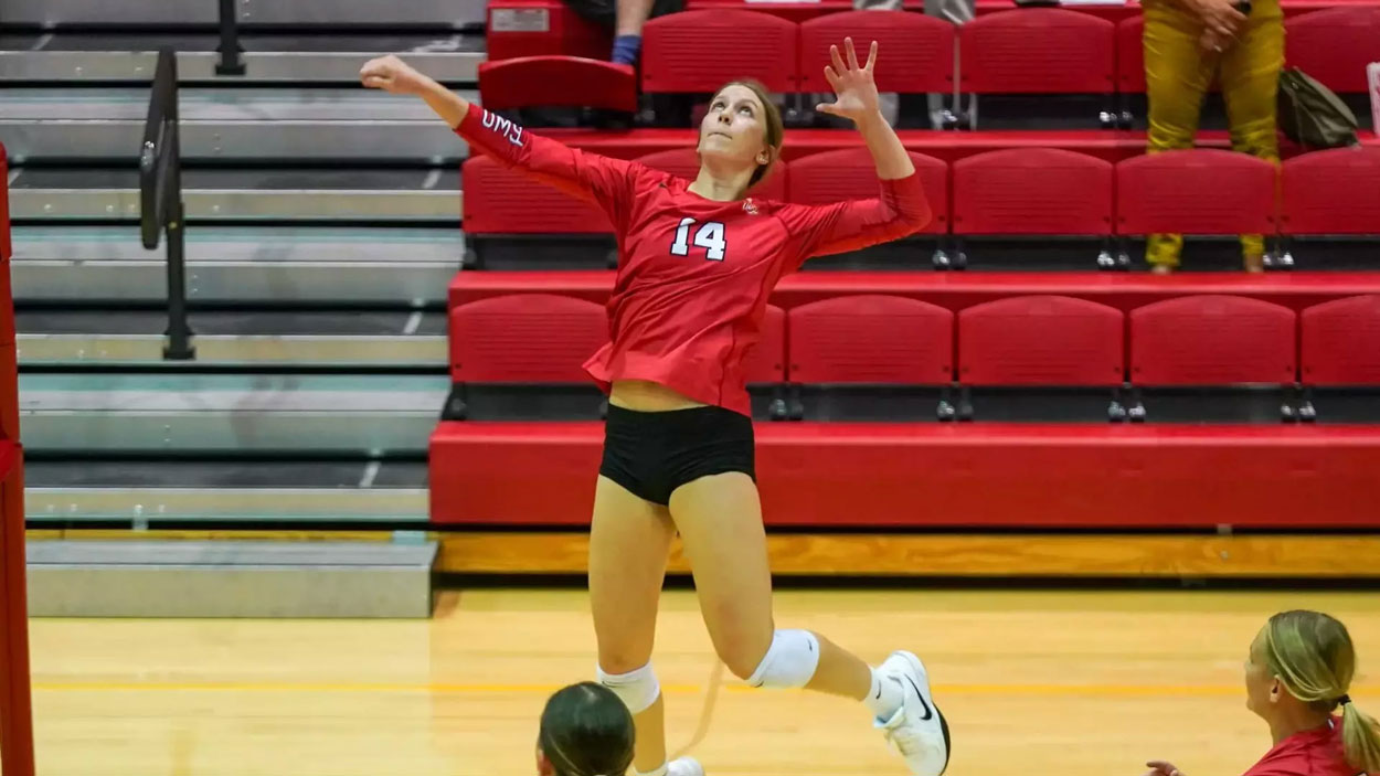 Outside hitter Alayna Santel leaps to swing at a ball in the air