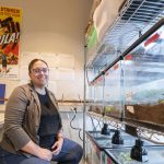 Doctoral candidate Becky Hansis-O'Neill sits near some of her tarantulas in Professor Aimee Dunlap's lab in the Research Building