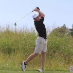 Golfer Benjamin yBerger follows through after hitting an iron shot