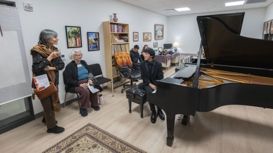 Senior computer science and music major Andy Mai talks to guests in one of newly renovated teaching spaces in the Creative Arts Building during an open house on Tuesday evening.