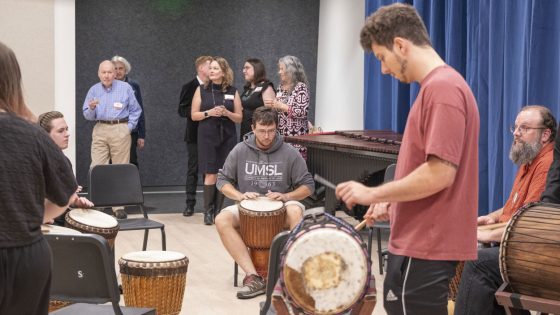 Guests listen to a drum rehearsal by UMSL students and Associate Teaching Professor Matt Henry in the new percussion room in the Creative Arts Building.