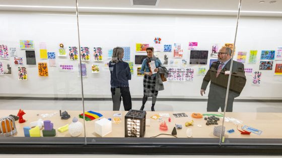 Guests look at some of the prints and sculptures on display in the Department of Art and Design's new lab space in the Creative Arts Building