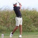 UMSL golfer Logan Mayo follows through after hitting a tee shot