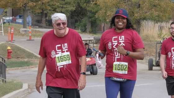 Alums Fred Faust and Melissa Anson walked across the finish of the UMSL 5K Run and Walk
