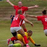 Oliva Lautz (top) celebrates her goal with teammates Sophia Beedle and Danni Cotter in the 38th minute of Friday's 3-0 victory over Upper Iowa