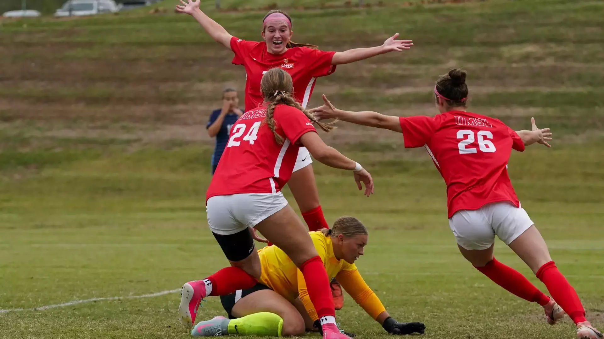 Oliva Lautz (top) celebrates her goal with teammates Sophia Beedle and Danni Cotter in the 38th minute of Friday's 3-0 victory over Upper Iowa