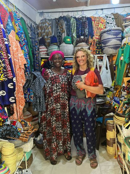 Violaine White stands with a Senegalese woman in a market in Dakar