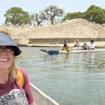 Associate Teaching Professor Violaine White takes a ride in a pirogue near Joal-Fadiouth in Senegal