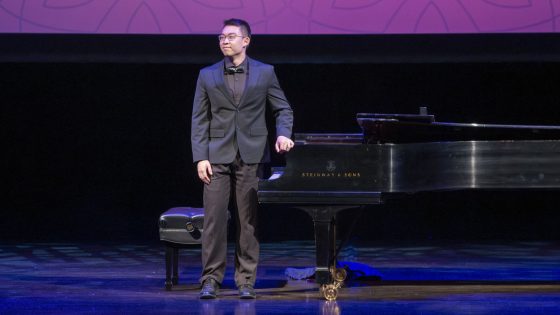 Eric Zhang stands up and prepares to take a bow after his performance at the 2025 Founders Celebration on Sept. 26
