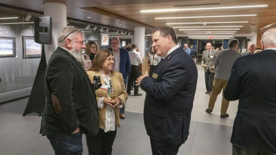 Christopher Dames (at right), UMSL's dean of libraries, speaks to guests during a reception
