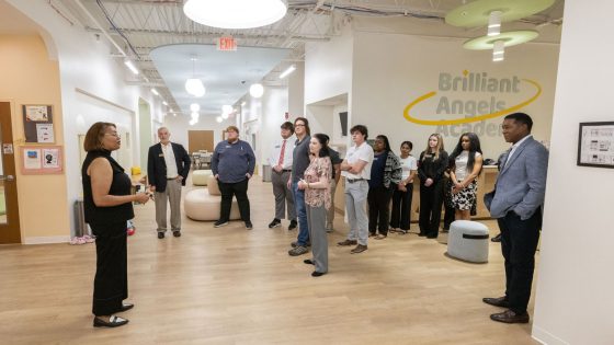 Pastor Beverly Jenkins shows members of the NextGen Leaders inaugural class the Brilliant Angels Academy childcare space at Refuge & Restoration Marketplace.
