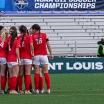 Members of the UMSL women's soccer team huddle on the field during their national quarterfinal match against Washburn