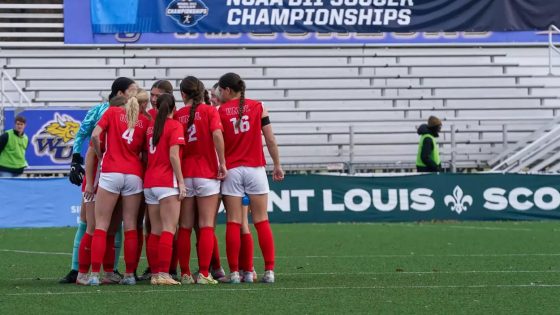 Members of the UMSL women's soccer team huddle on the field during their national quarterfinal match against Washburn