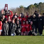 Members of the UMSL women's soccer team with their Midwest Region championship trophy