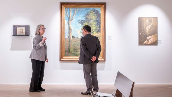 Julie Dunn-Morton gives Mun Y. Choi a tour of the Wallace H. Smith Gallery of Art 