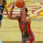 Women's basketball forward Mara Reider prepares to shoot with a defender looking on from behind her