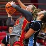 Morgan Ramthun shoots while being closely guarded by an Upper Iowa defender
