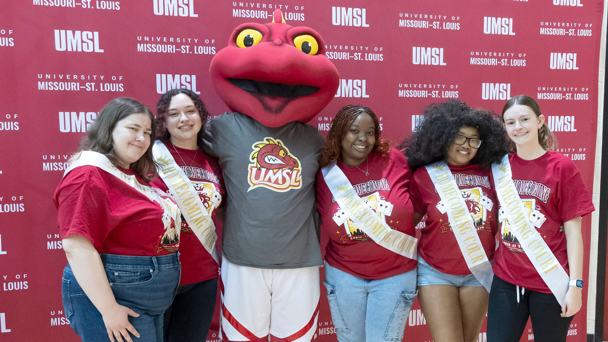 Members of the homecoming court with Louie the Triton