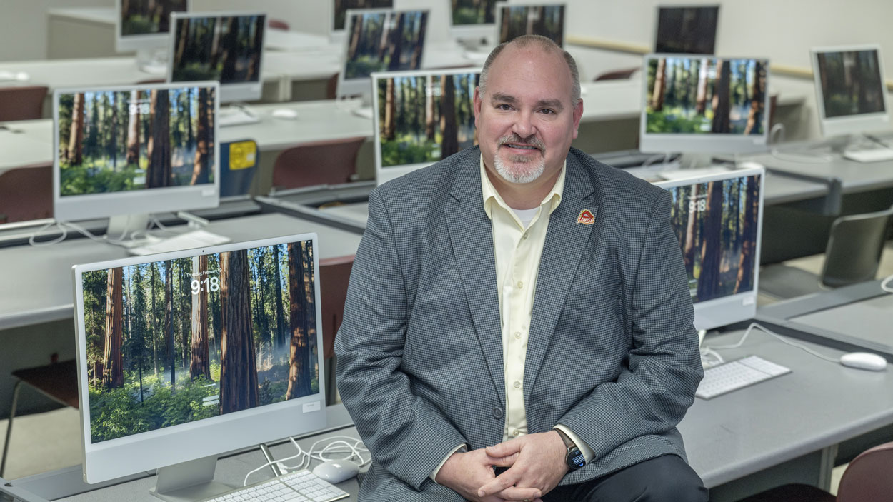 Chris Scheetz sitting in a computer lab