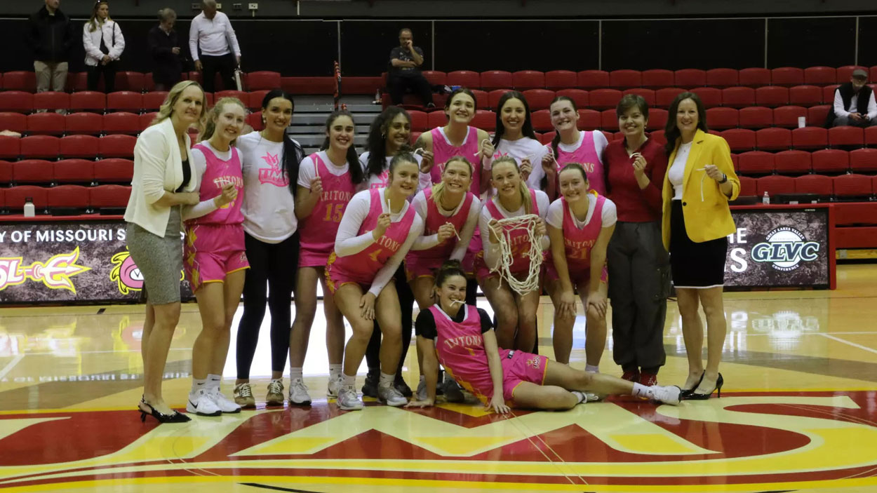 Members of the UMSL women's basketball team pose for a picture after clinching the GLVC regular-season title