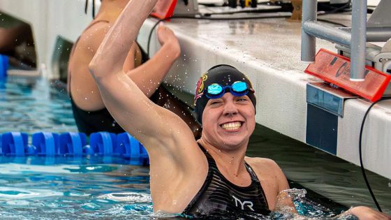 UMSL swimmer Justice Beard celebrates after her first-place finish in the 200-yard freestyle race at the 2026 GLVC Swimming and Diving Championships